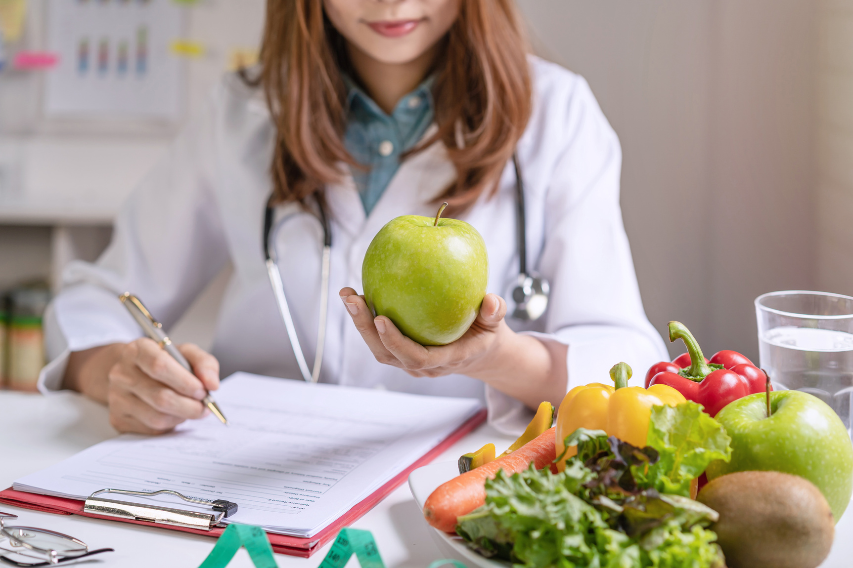 Nutritionist giving consultation to patient with healthy fruit and vegetable, Right nutrition and diet concept